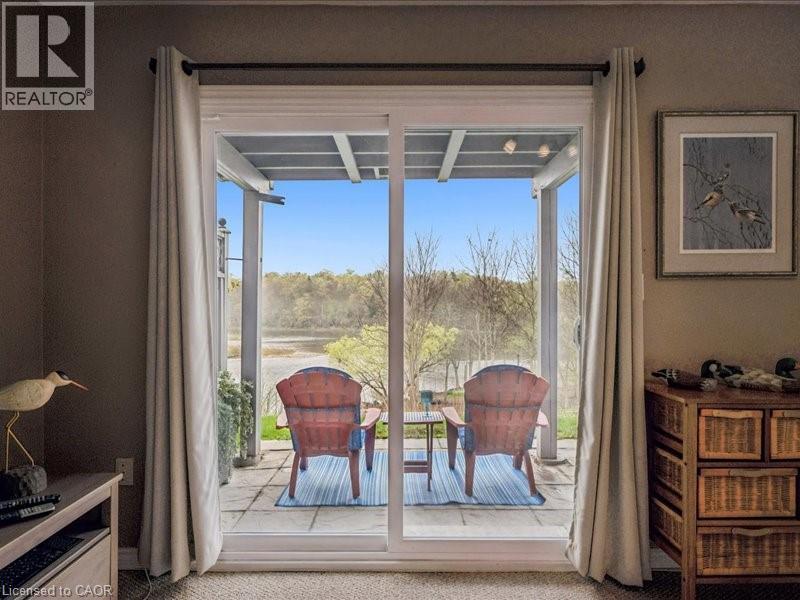 Sliding glass doors opening to an outdoor patio with water frontage - 245 Bishop Street S Unit# 4, Cambridge, ON - Indoor
