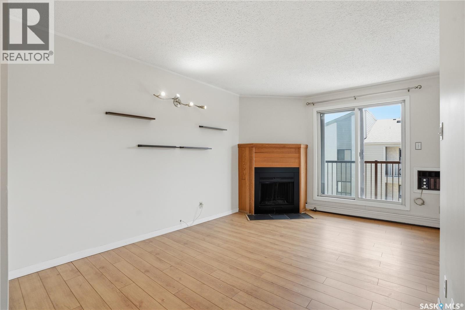 316B 4040 8Th Street E, Saskatoon, SK - Indoor Photo Showing Living Room With Fireplace