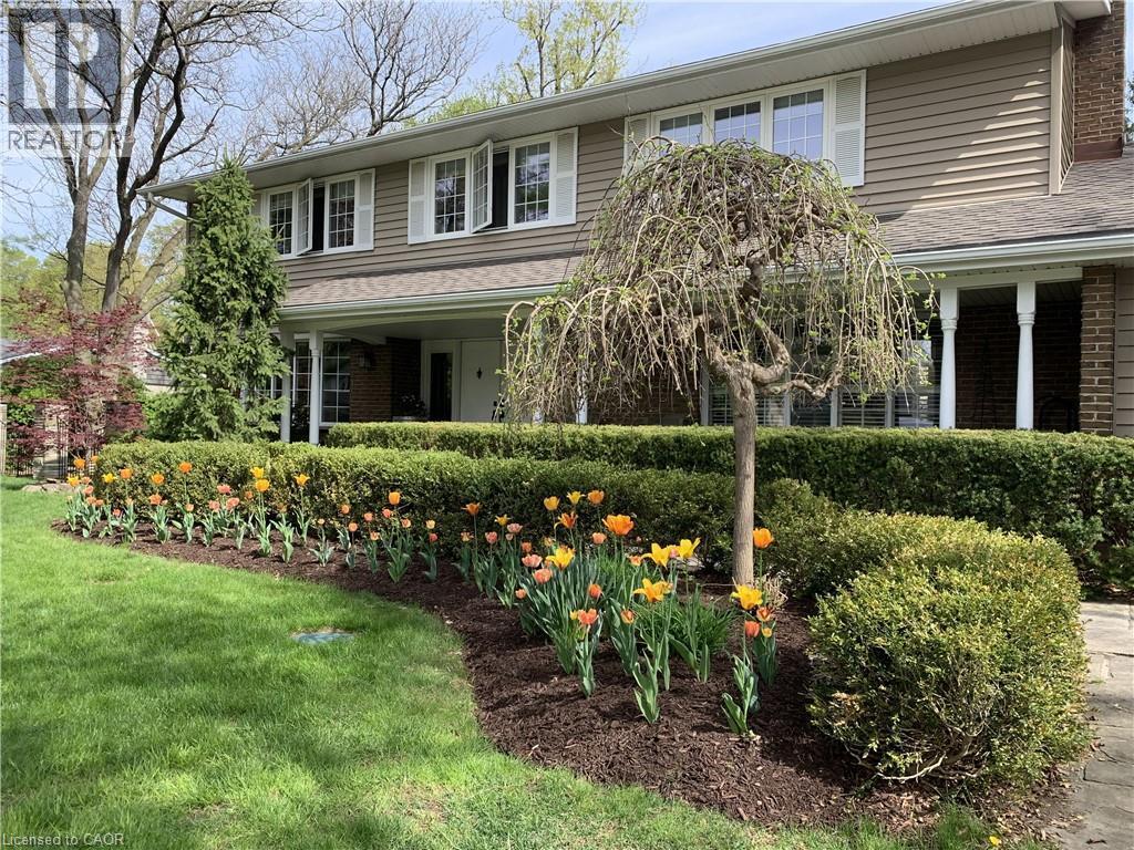 Two-story residence featuring horizontal siding, white window shutters, and a covered entry with white columns - 514 Colonial Drive, Waterloo, ON - Outdoor