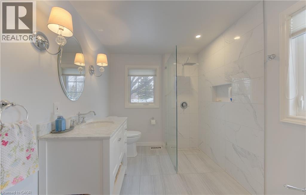 Modern bathroom featuring a spacious glass-enclosed shower with tiled walls and a built-in niche - 514 Colonial Drive, Waterloo, ON - Indoor Photo Showing Bathroom