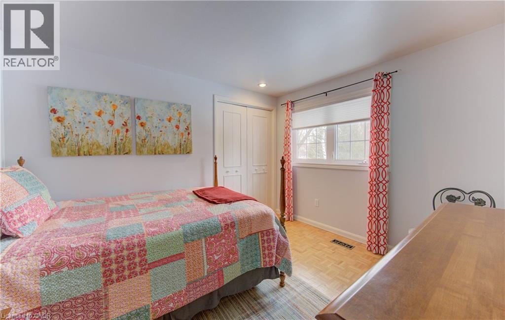 Bright interior space with light-colored walls and wood-finish flooring - 514 Colonial Drive, Waterloo, ON - Indoor Photo Showing Bedroom