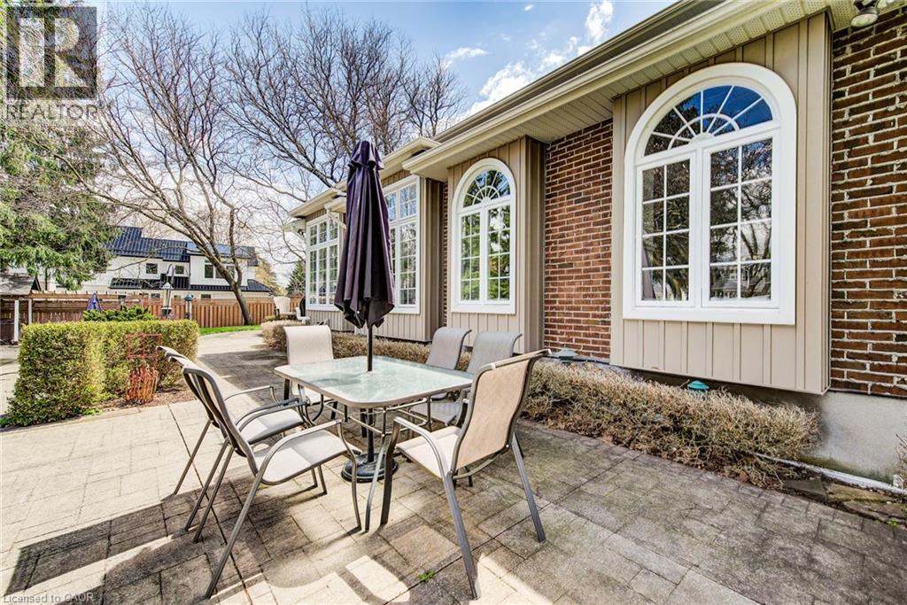 Brick exterior with arched windows featuring white muntins - 514 Colonial Drive, Waterloo, ON - Outdoor With Deck Patio Veranda