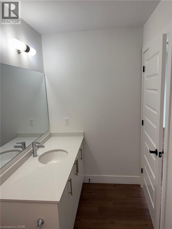 Bathroom with vanity, baseboards, and wood finished floors - 1000 Lackner Place Unit# 401, Kitchener, ON - Indoor Photo Showing Bathroom