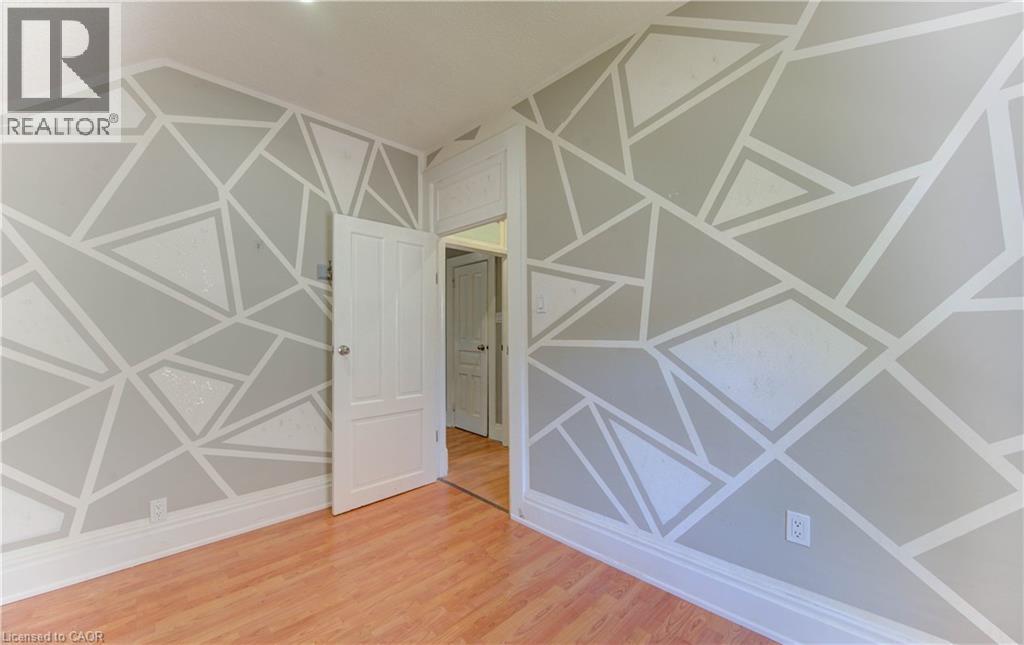 Empty room featuring light wood finished floors - 138 Courtland Avenue E, Kitchener, ON - Indoor Photo Showing Other Room