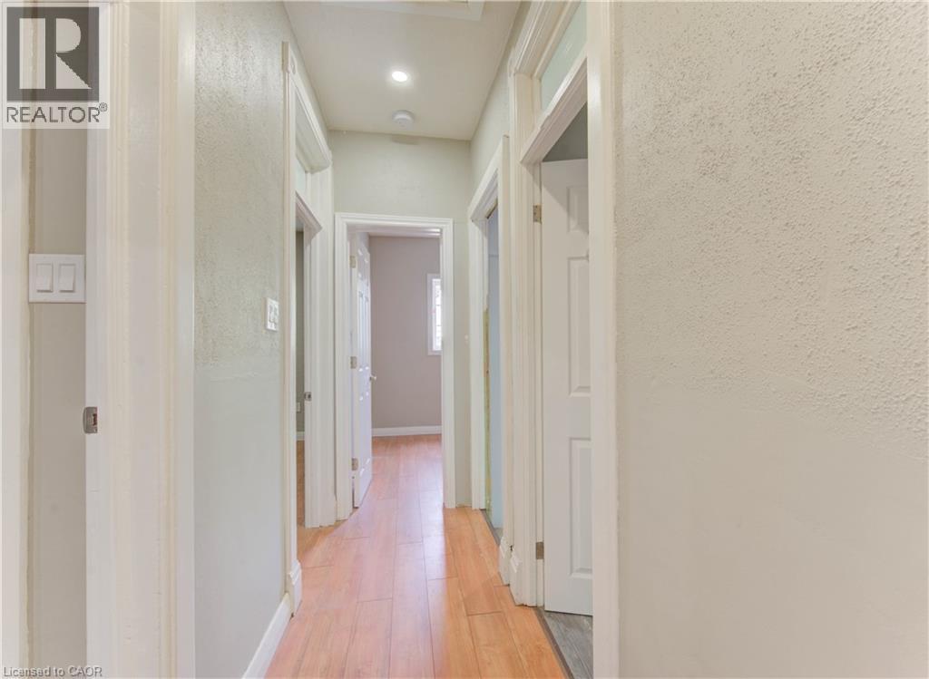 Hallway with light wood-style flooring and baseboards - 138 Courtland Avenue E, Kitchener, ON - Indoor Photo Showing Other Room