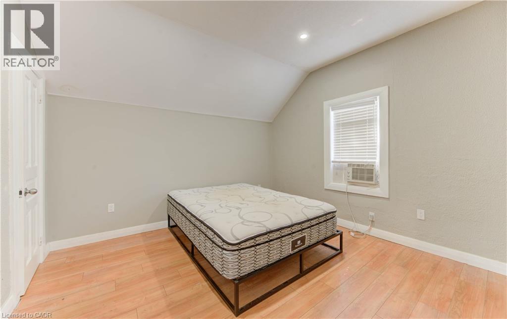 Bedroom featuring lofted ceiling, light wood-style floors, and recessed lighting - 138 Courtland Avenue E, Kitchener, ON - Indoor Photo Showing Bedroom