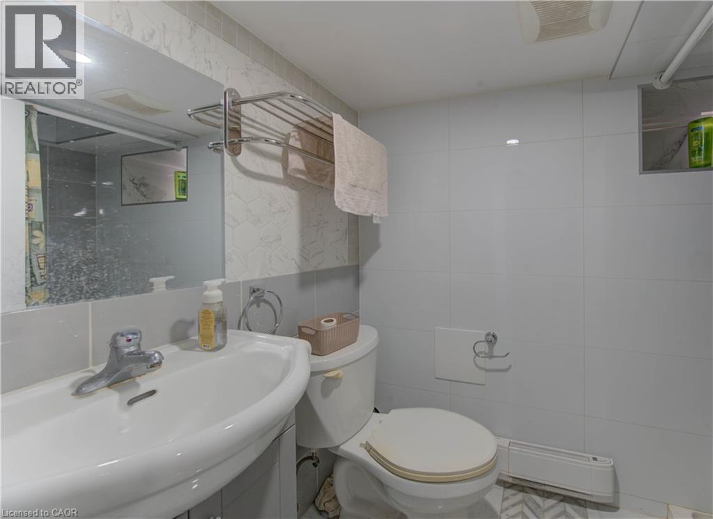 Bathroom featuring a sink and tile walls - 138 Courtland Avenue E, Kitchener, ON - Indoor Photo Showing Bathroom