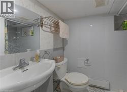 Bathroom featuring a sink and tile walls -