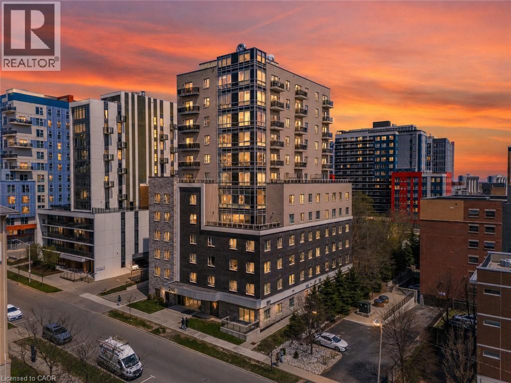 Modern high-rise building featuring a multi-story facade, extensive window lines, individual balconies, and street-level pedestrian access - 246 Lester Street Unit# Ph-03, Waterloo, ON - Outdoor With Balcony With Facade