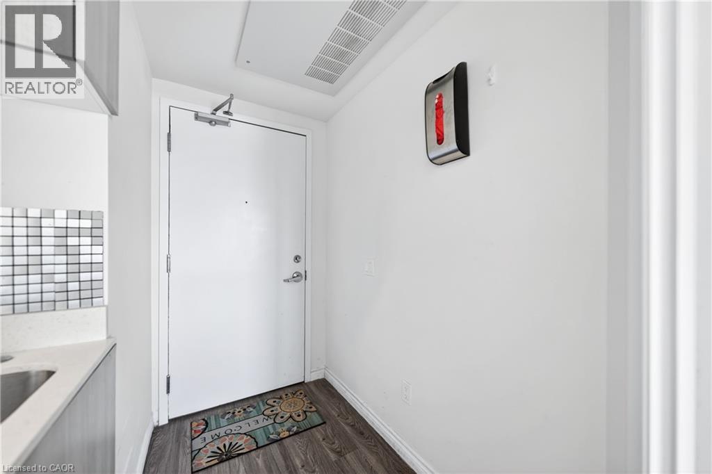 Entryway featuring wood-finish flooring, white walls, and a door with chrome hardware - 246 Lester Street Unit# Ph-03, Waterloo, ON - Indoor Photo Showing Other Room