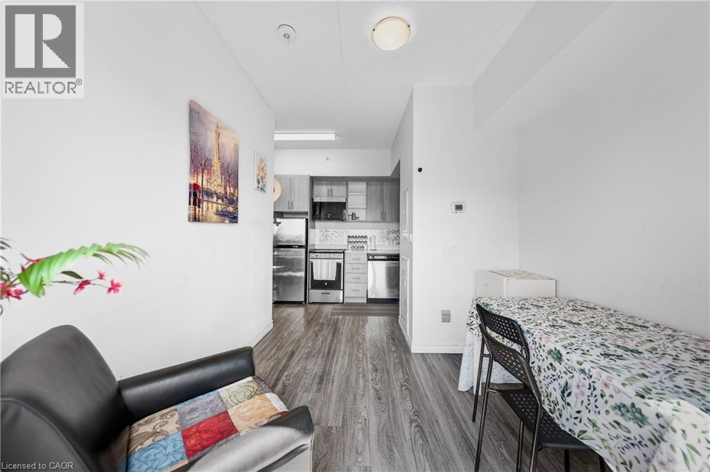Open-concept living space with wood-finish flooring extending into the kitchen - 246 Lester Street Unit# Ph-03, Waterloo, ON - Indoor Photo Showing Bedroom