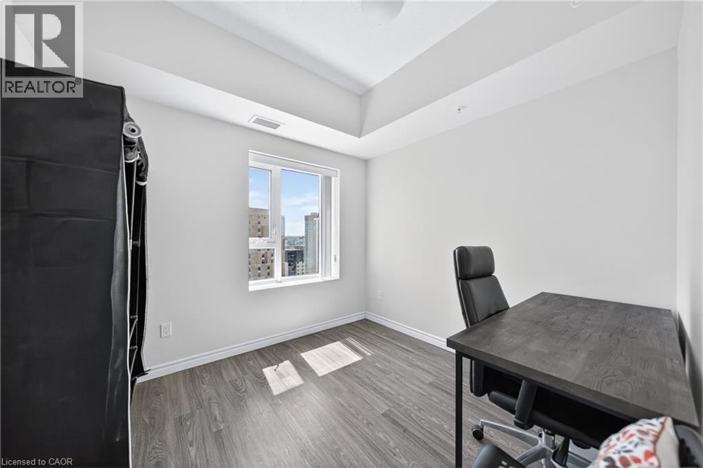 Bright room featuring wood-finish flooring, white baseboards, a large window, and high ceilings with tray detailing - 246 Lester Street Unit# Ph-03, Waterloo, ON - Indoor
