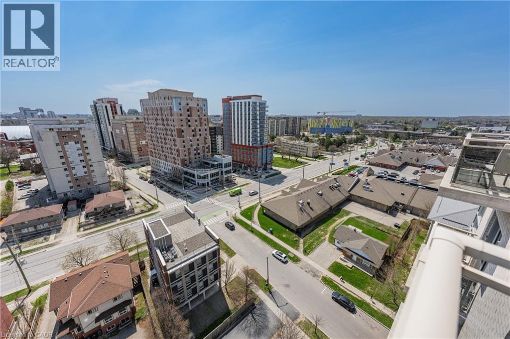 Expansive aerial perspective showcasing a vibrant urban environment with diverse architectural styles, including multi-story residential buildings and commercial structures - 246 Lester Street Unit# Ph-03, Waterloo, ON - Outdoor With View