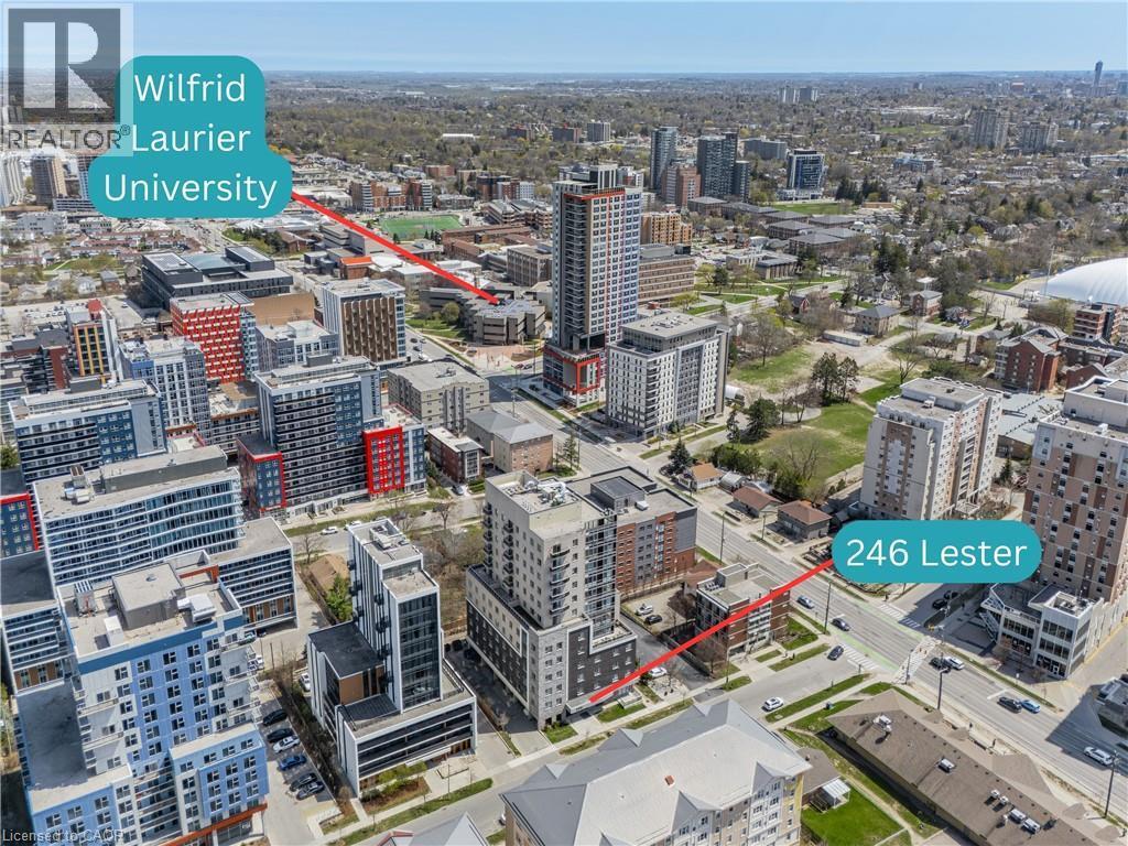 Aerial overview of a dense urban environment featuring multi-story residential and commercial buildings - 246 Lester Street Unit# Ph-03, Waterloo, ON - Outdoor With View