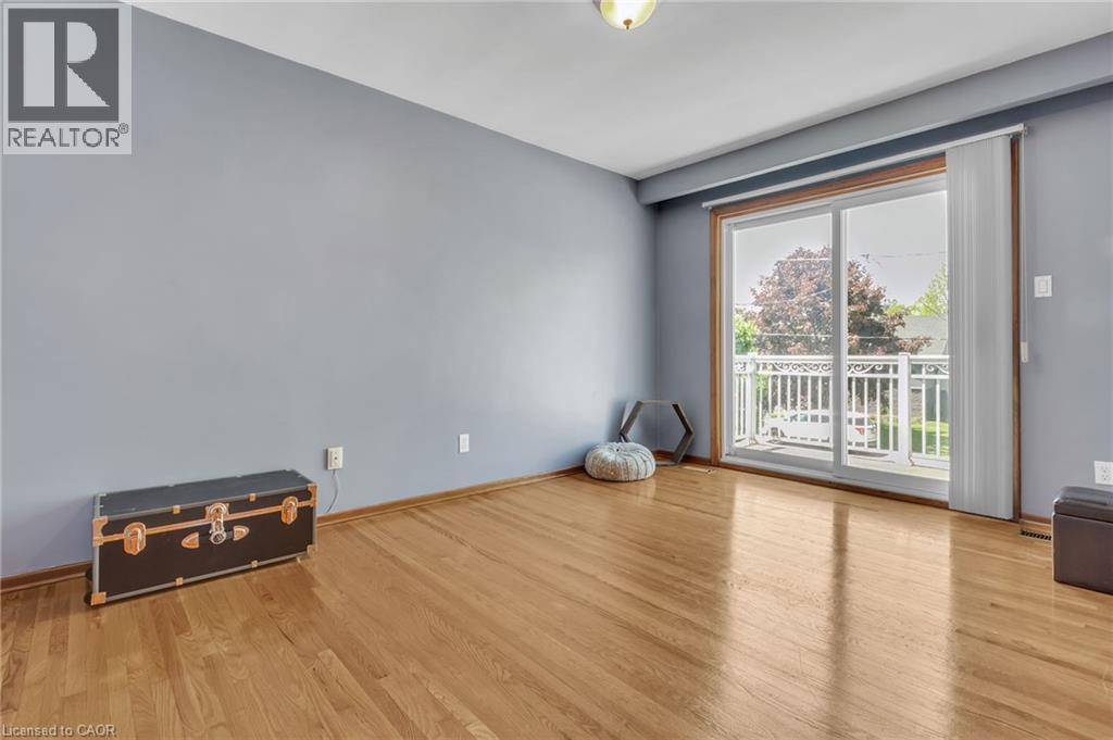 Spacious room featuring wood-finish flooring and light blue walls - 2344 Brinell Avenue, Burlington, ON - Indoor Photo Showing Other Room