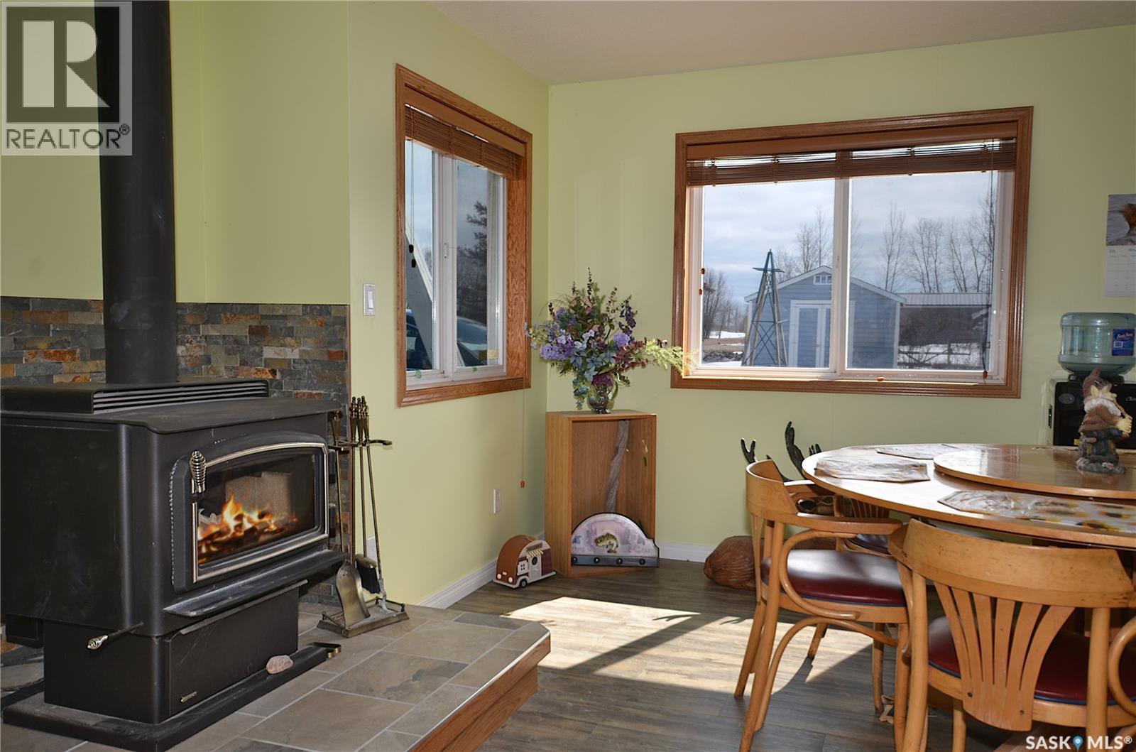 6 Bronco Drive, Delaronde Lake, SK - Indoor Photo Showing Dining Room With Fireplace