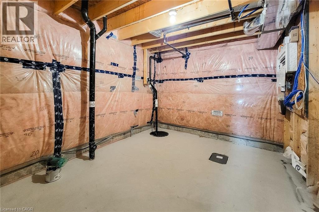 Unfinished basement space featuring visible insulation, exposed wooden joists, concrete flooring, and utility piping - 111 Alicia Crescent, Thorold, ON
