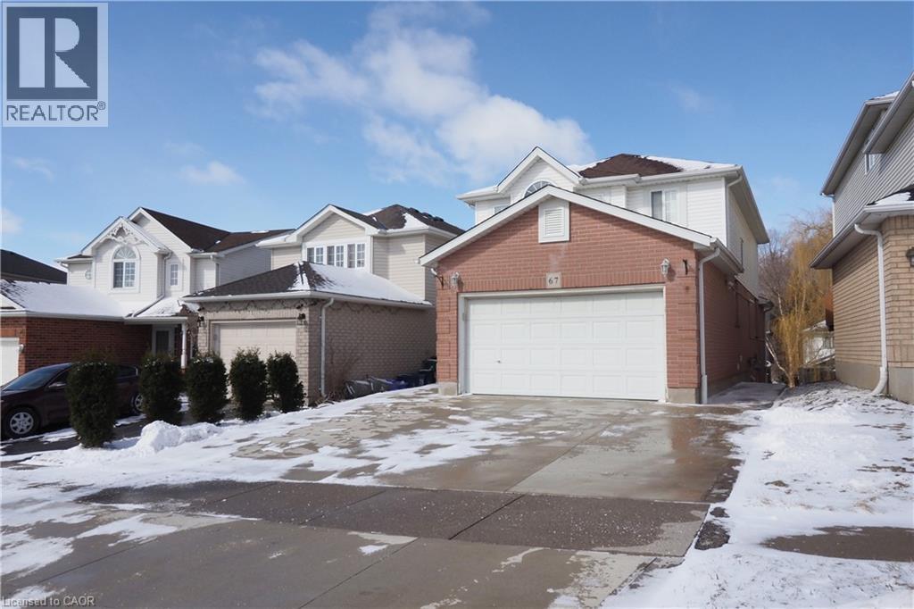 Brick and siding exterior featuring an integrated two-car garage with white door - 67 Hollyridge Crescent Unit# Lower, Kitchener, ON - Outdoor