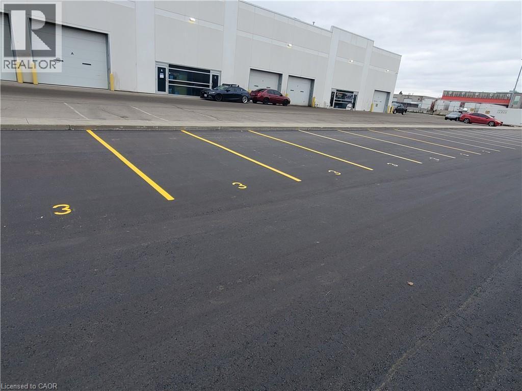 Paved asphalt parking area with clearly delineated yellow parking lines and numerical space markers - 44 Ditton Drive Unit# 3, Hamilton, ON