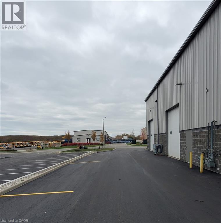 Industrial building featuring corrugated metal siding and a stone block base - 44 Ditton Drive Unit# 3, Hamilton, ON