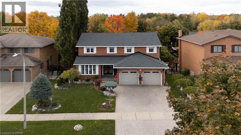 Brick two-story residence featuring white window shutters and a dark shingle roof - 228 Michener Crescent, Kitchener, ON - Outdoor With Facade