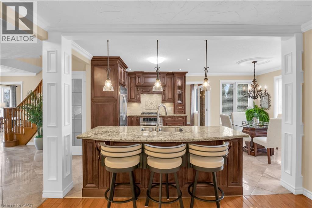 Custom kitchen island featuring a granite countertop and built-in sink - 228 Michener Crescent, Kitchener, ON - Indoor Photo Showing Other Room