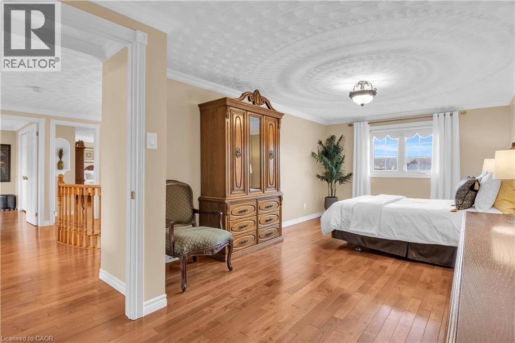 Hardwood flooring throughout, crown molding, and a decorative ceiling medallion - 228 Michener Crescent, Kitchener, ON - Indoor Photo Showing Bedroom
