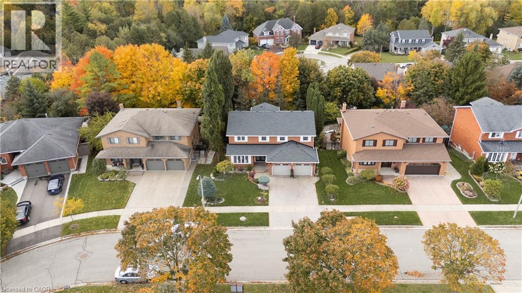 Brick-clad home featuring a two-car garage, dormer windows, and a covered front entry - 228 Michener Crescent, Kitchener, ON - Outdoor With View