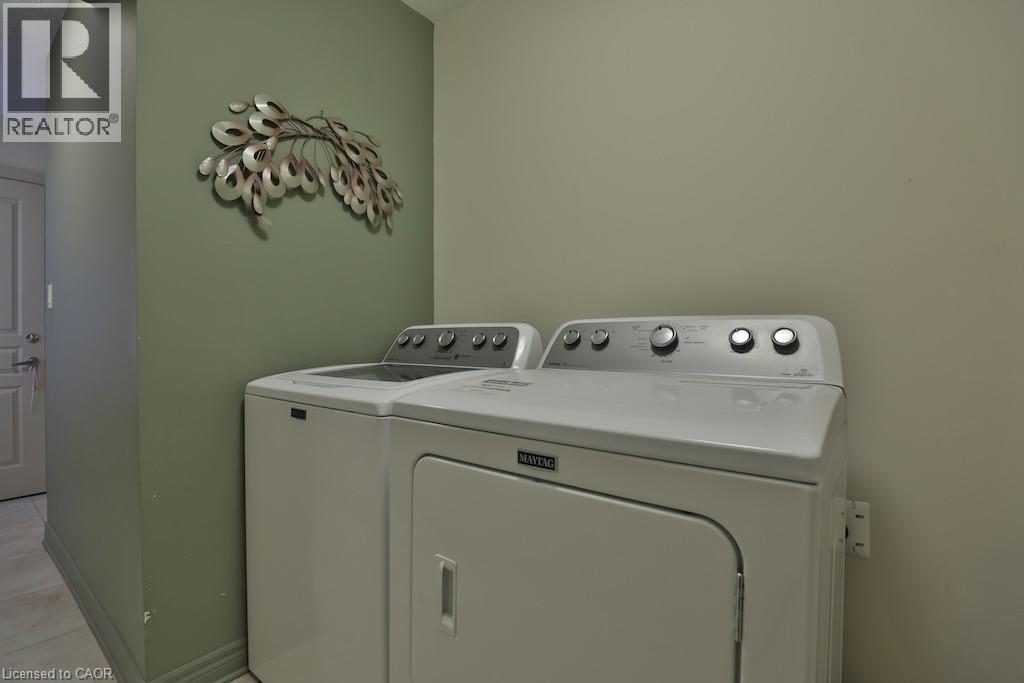 Dedicated laundry area featuring a white top-load washing machine and a white front-load dryer - 7 Gibson Place Unit# 21, St. Catharines, ON - Indoor Photo Showing Laundry Room