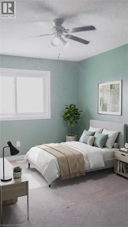 Bedroom featuring a flush-mount ceiling fan with integrated lighting, a large window with white trim, and light-colored carpeting. Virtually staged. - 569 Activa Avenue, Kitchener, ON - Indoor Photo Showing Bedroom