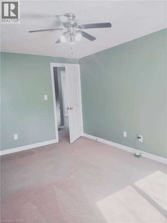 Interior room featuring light green walls, a white ceiling, and light-colored carpeting - 569 Activa Avenue, Kitchener, ON - Indoor
