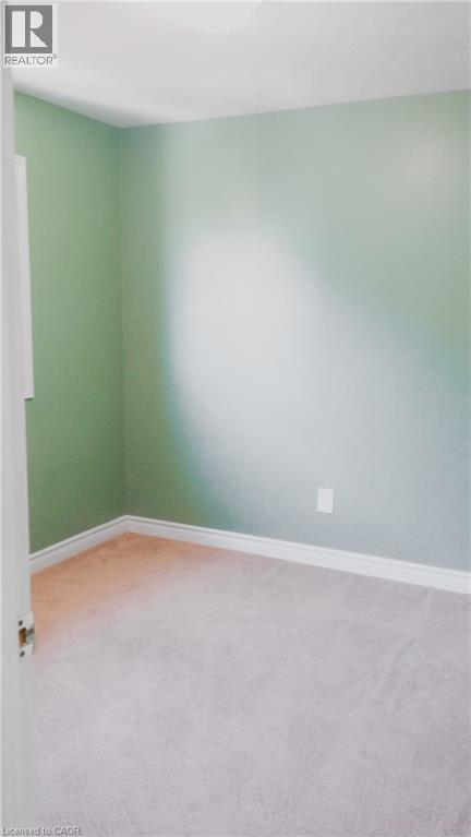 Interior room with light green walls and neutral-toned carpeting - 569 Activa Avenue, Kitchener, ON - Indoor Photo Showing Other Room
