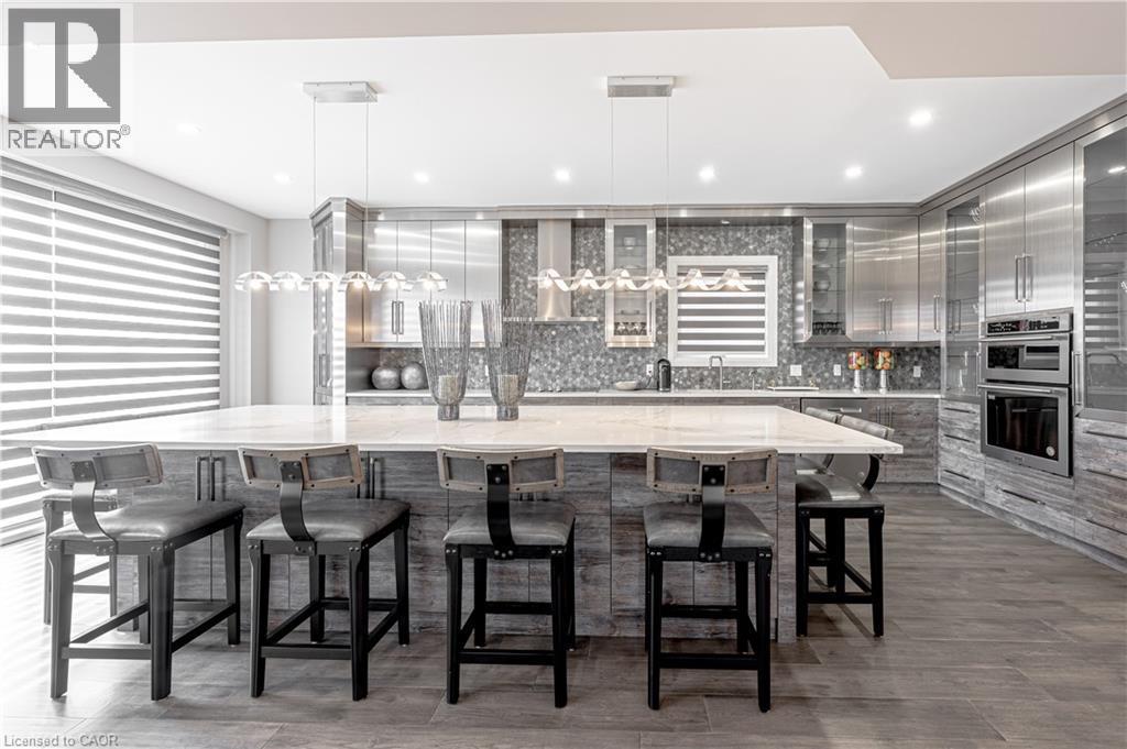 Kitchen with gray cabinetry, tasteful backsplash, double oven, and modern cabinets - 477 Blair Creek Drive, Kitchener, ON - Indoor