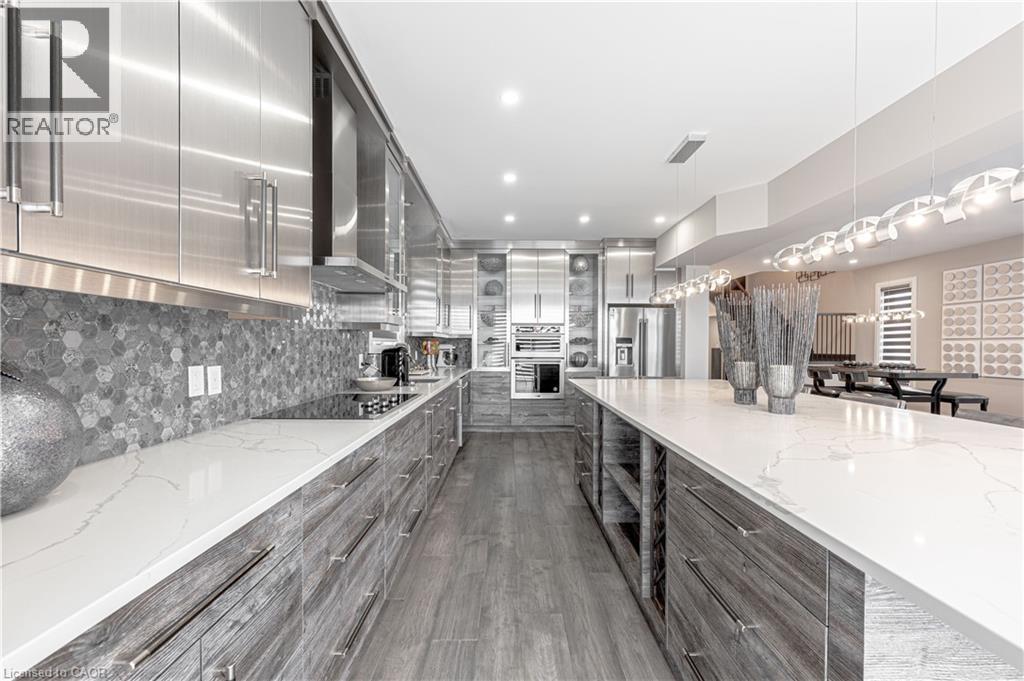 Kitchen featuring wall chimney exhaust hood, modern cabinets, gray cabinets, stainless steel fridge, and black electric stovetop - 477 Blair Creek Drive, Kitchener, ON - Indoor Photo Showing Kitchen With Upgraded Kitchen