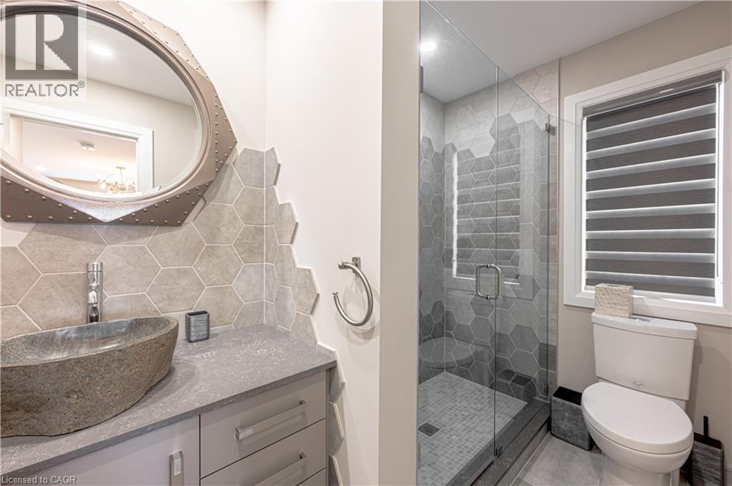 Bathroom with toilet, vanity, a shower stall, and decorative backsplash - 477 Blair Creek Drive, Kitchener, ON - Indoor Photo Showing Bathroom
