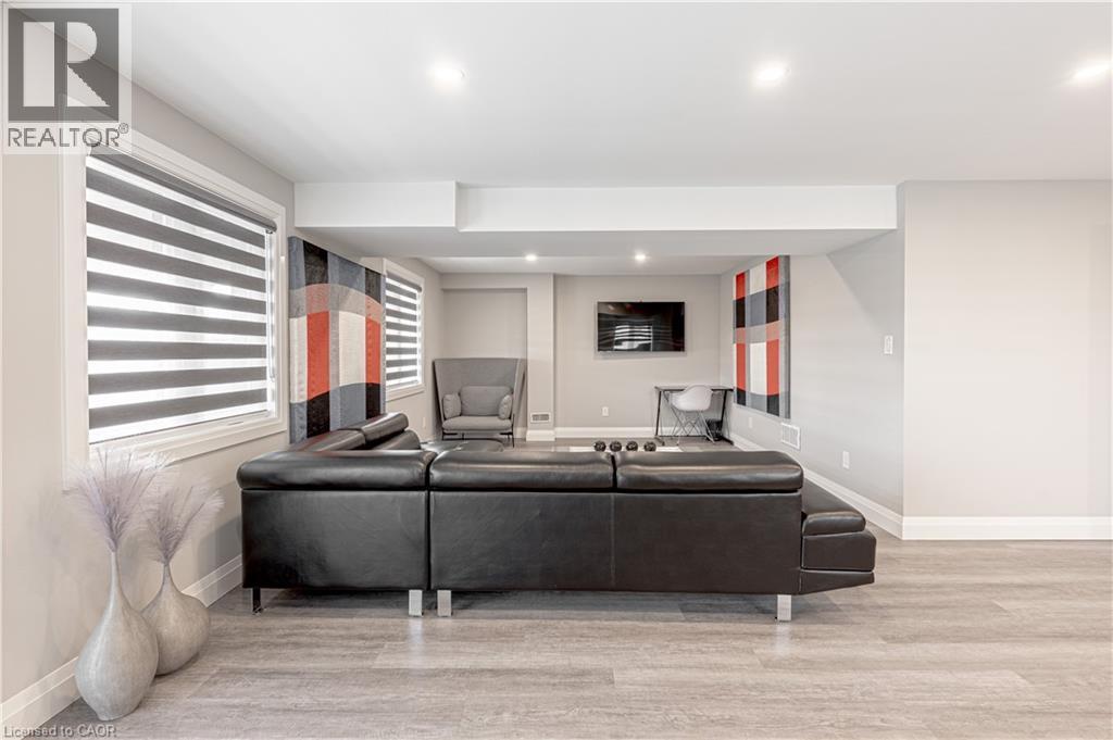 Living room with wood finished floors, baseboards, and recessed lighting - 477 Blair Creek Drive, Kitchener, ON - Indoor