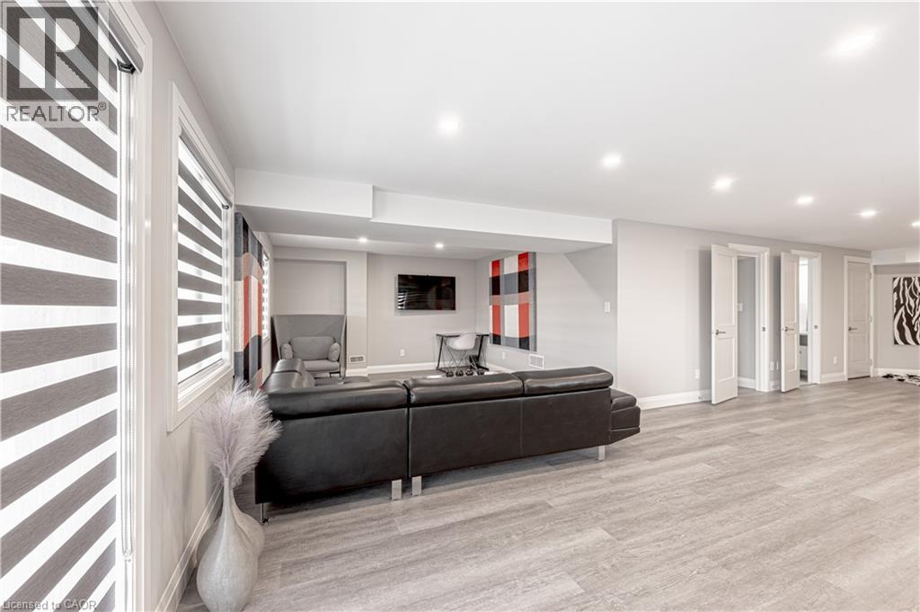 Living room featuring recessed lighting, baseboards, and wood finished floors - 477 Blair Creek Drive, Kitchener, ON - Indoor