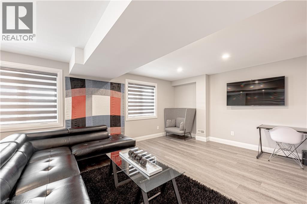 Living room featuring baseboards, recessed lighting, and wood finished floors - 477 Blair Creek Drive, Kitchener, ON - Indoor