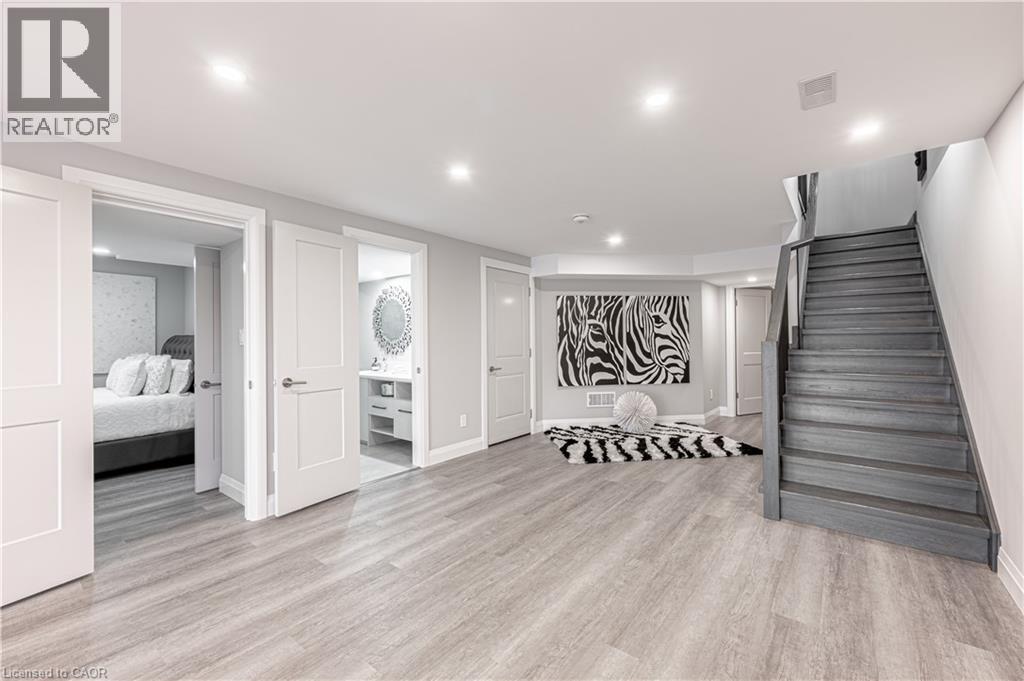 Finished below grade area featuring visible vents, recessed lighting, light wood-style flooring, baseboards, and stairway - 477 Blair Creek Drive, Kitchener, ON - Indoor Photo Showing Other Room
