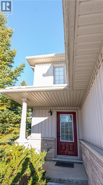Entrance to property featuring board and batten siding - 85 Bankside Drive Unit# E34, Kitchener, ON - Outdoor With Exterior