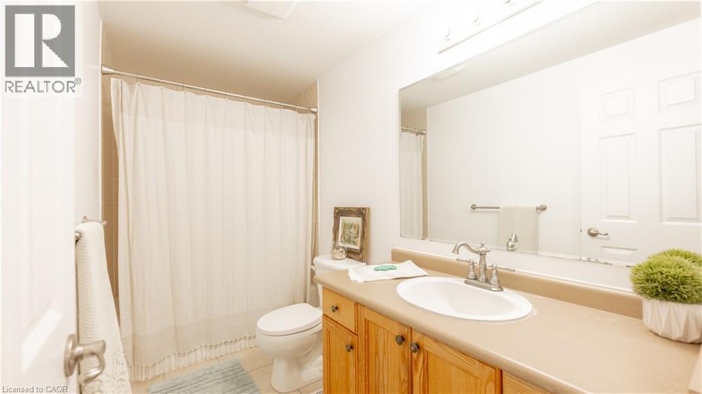 Bathroom featuring vanity, toilet, and tile patterned floors - 85 Bankside Drive Unit# E34, Kitchener, ON - Indoor Photo Showing Bathroom