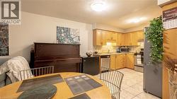 Kitchen featuring appliances with stainless steel finishes, a sink, light countertops, light brown cabinets, and backsplash -