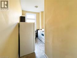 Kitchen area featuring a window, tile flooring, and light-colored walls -