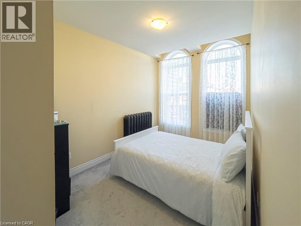 Interior room with a neutral wall color and carpet flooring - 85 King Street W, Kitchener, ON