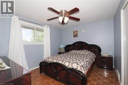 Room featuring wood-finish parquet flooring and a ceiling fan with integrated lighting -