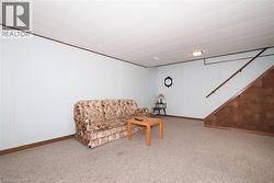 Carpeted interior space featuring light-colored walls and a drop ceiling -