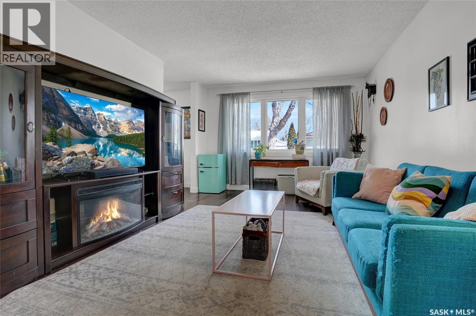 23 Scrivener Crescent, Regina, SK - Indoor Photo Showing Living Room With Fireplace