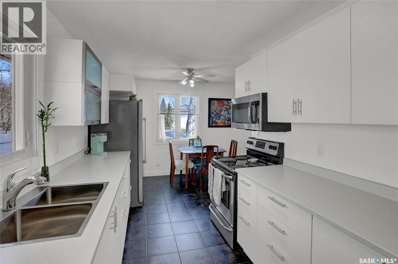 23 Scrivener Crescent, Regina, SK - Indoor Photo Showing Kitchen With Double Sink