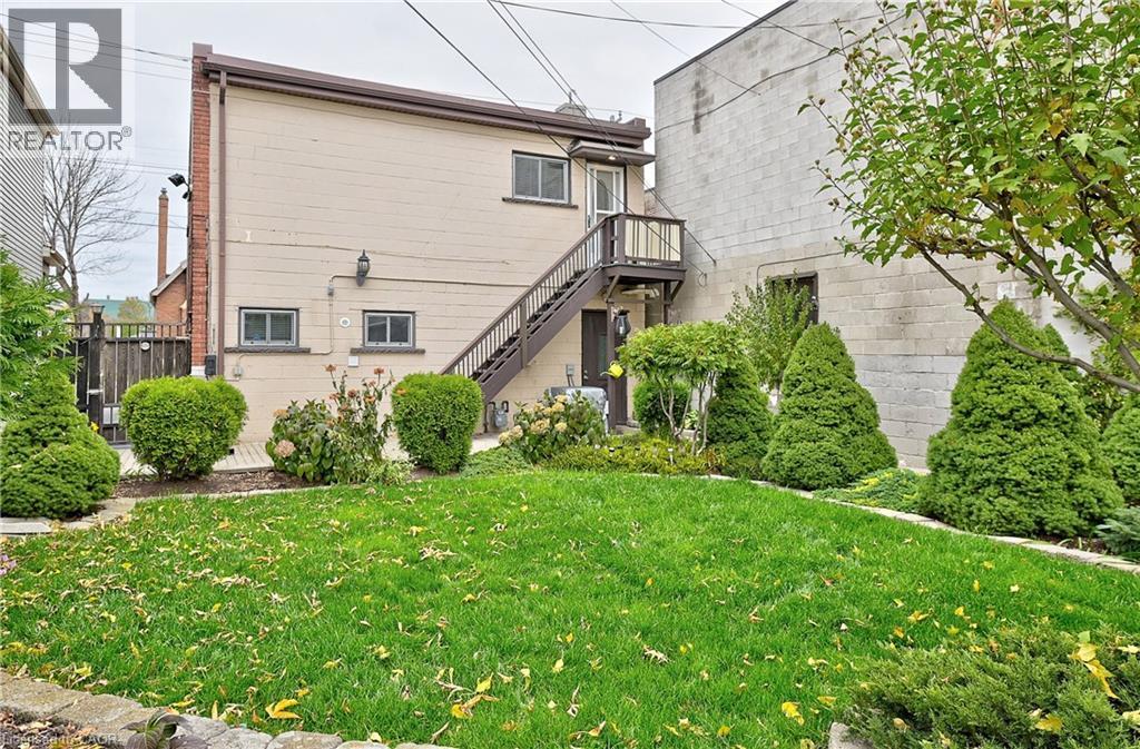 Grassed yard with established perimeter landscaping and mature trees - 1476 Barton Street E, Hamilton, ON - Outdoor