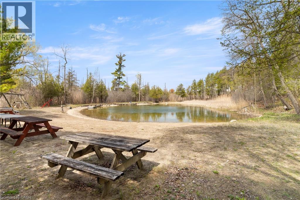 Exclusive access to private amenities including 18 acres of scenic walking trails, a tennis court, a swimming pond, and a residents-only beach. - 24 Grand Hill Drive, Kitchener, ON - Outdoor With View